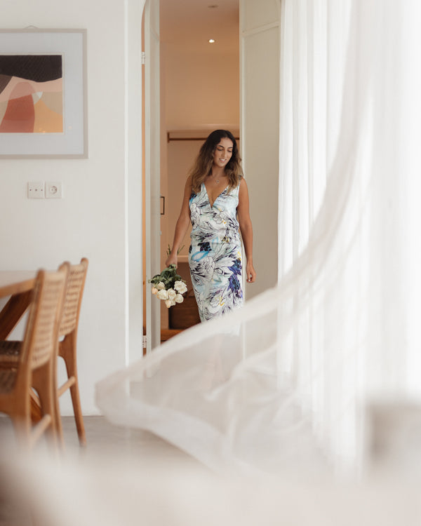 Our British model, Meena, wearing Sophia Nilofar Silk Slip Dress while walking on a villa entrance