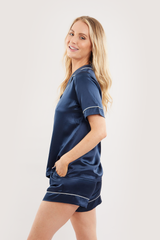 Our model wearing short-sleeve Eva Navy silk pyjama set on white background - side look