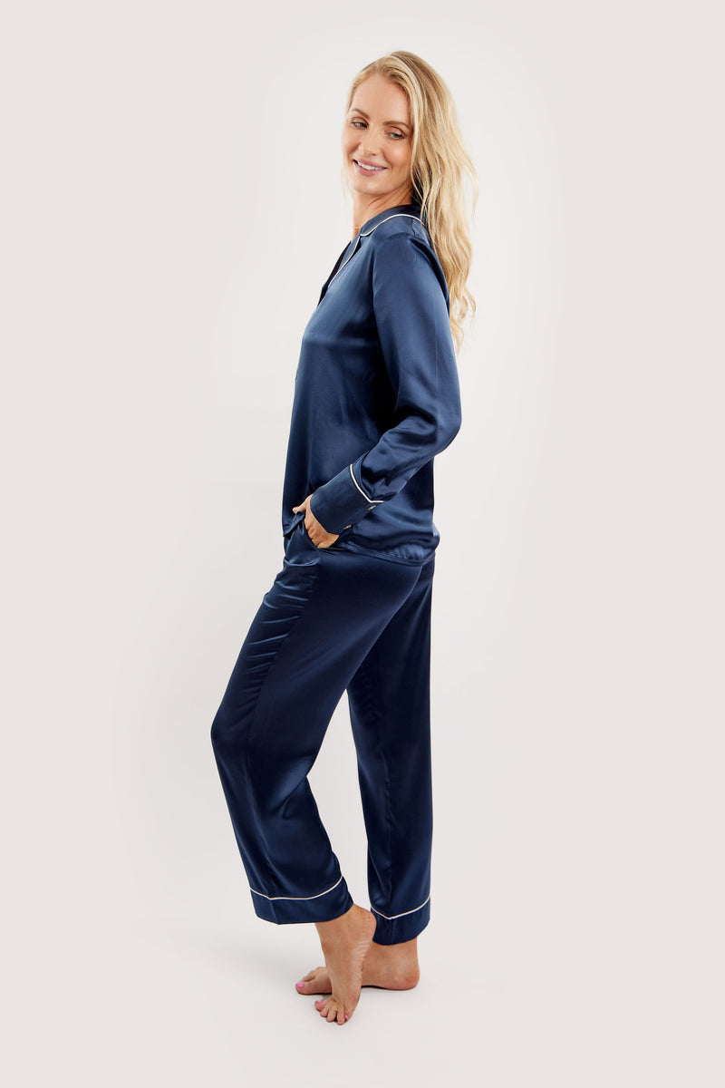 Our model wearing long-sleeve Rose Navy silk pyjama set on white background - side look