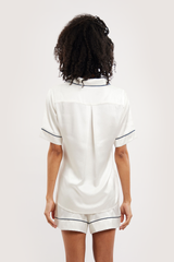 Our model wearing short-sleeve Eva Ivory silk pyjama set on white background - back look
