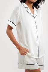 Our model wearing short-sleeve Eva Ivory silk pyjama set on white background - side close-up look