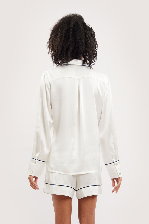 Our model wearing long-sleeve Iris Ivory silk pyjama set on white background - back look