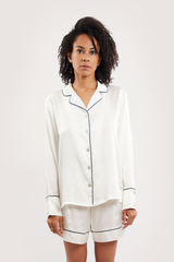 Our model wearing long-sleeve Iris Ivory silk pyjama set on white background - front look