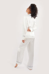Our model wearing long-sleeve Rose Ivory silk pyjama set on white background - sideway look - version two