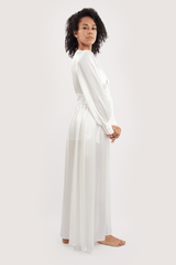 Our model wearing Sophia Ivory silk slip dress on white background - side look