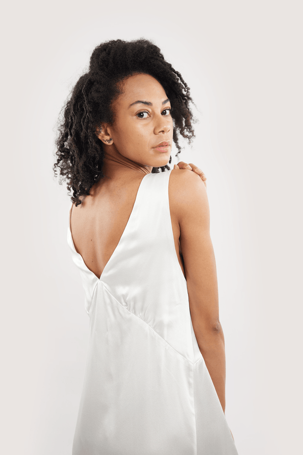 Our model wearing Sophia Ivory silk slip dress on white background - back close-up look