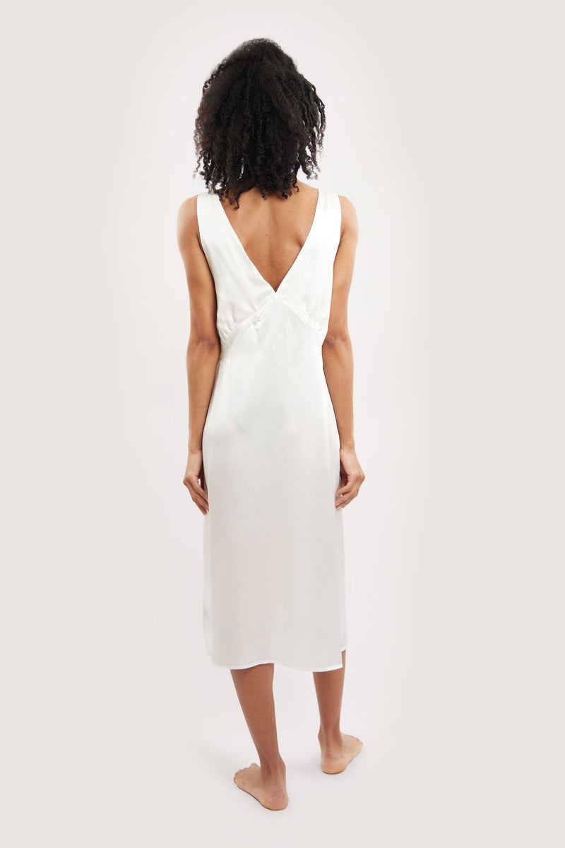 Our model wearing Sophia Ivory silk slip dress on white background - back look