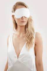 Our model wearing Ivory silk eye mask on white background - eyes closed