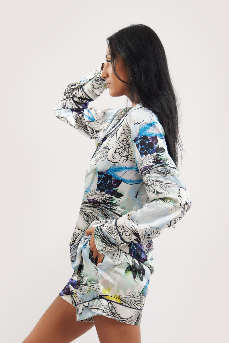 Our model wearing long-sleeve Iris Nilofar silk pyjama set on white background - side look